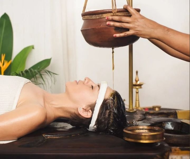 Shirodhara Ayurvedic oil flow therapy session at Pranavam Ayurveda Hospital in Kozhikode, Kerala